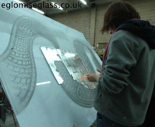 applying silver leaf on the back of the glass sheet